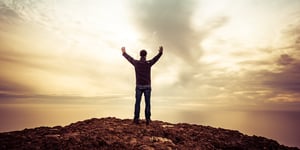 A man with arms outstretched, looking into the sun, exemplifying transcendental desires.