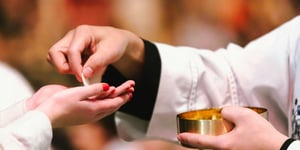 A woman receiving the body of Christ. 