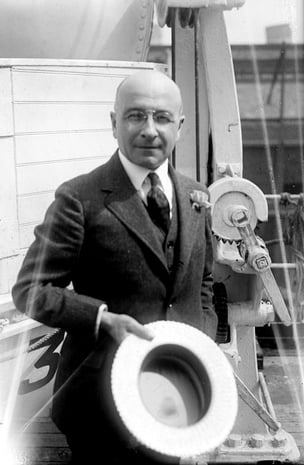Dr. Alexis Carrel on a ship taking his hat off. 