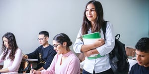A girl holding books ready to receive education.