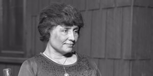 Helen Keller holding a magnolia, c. 1920