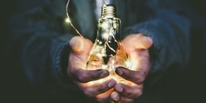 Man holding lightbulb.