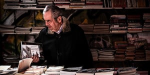 Elderly man in a bookstore.