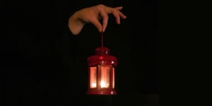 A person holdig a lantern.