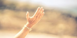 A hand reaching to the sky.