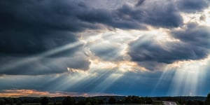 Sun breaking through stormy clouds.