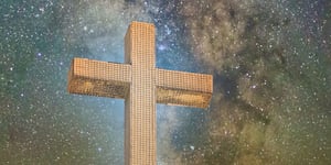Cross in front of a star filled sky. 