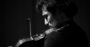 man playing violin with emotion