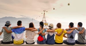 a group of friends with their arms around each other. 