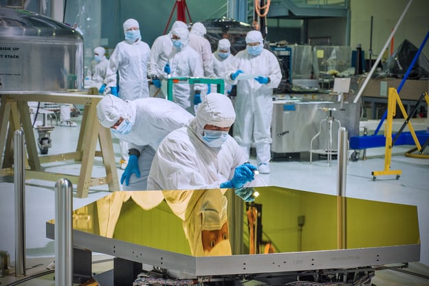 Engineers inspect one of the first two flight mirrors to arrive at NASA Goddard.