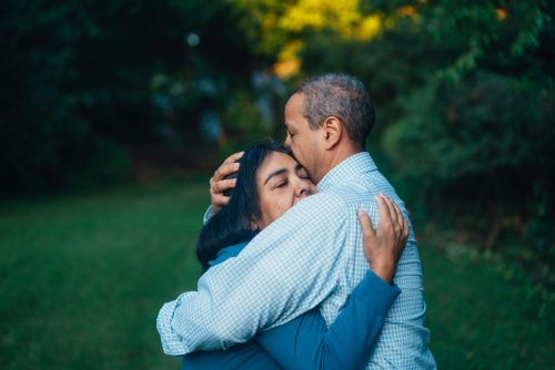 man and woman embracing on lawn