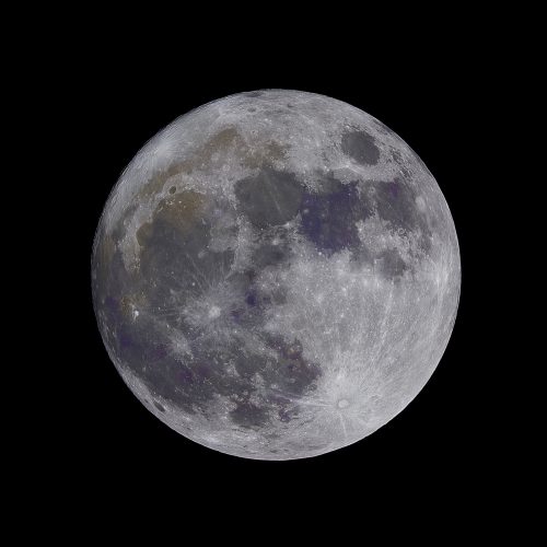 lunar craters visible on moon in dark night sky