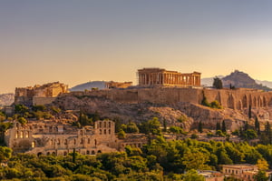 A picture of a city from a high place on a surrounding mountain.