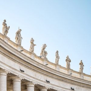 row of statues of saints against blue sky outside the Vatican