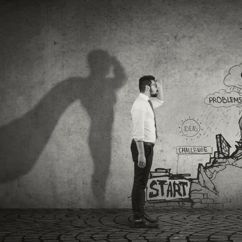 Man standing at the beginning with his shadow wearing a cape.