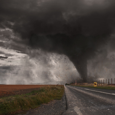 A tornado passing over a highway.