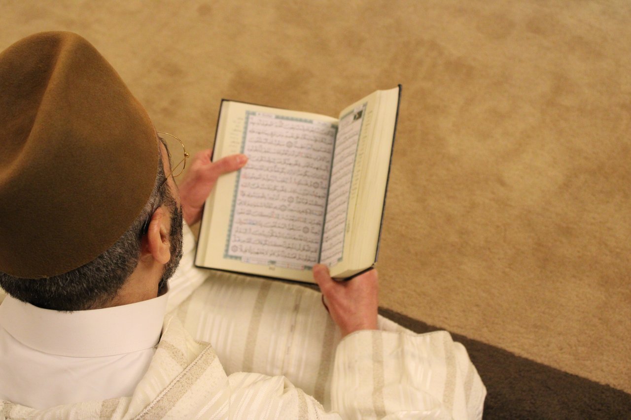 a man reading religious text.