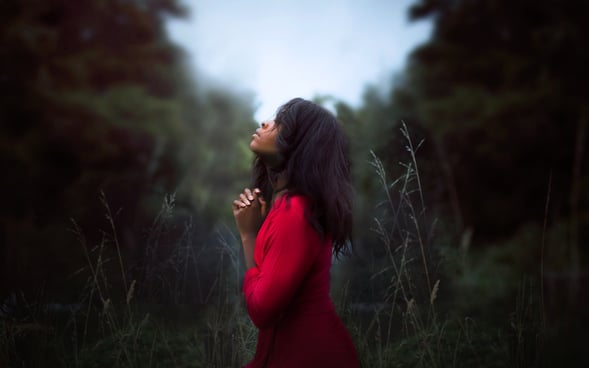 A woman praying for a perfect home